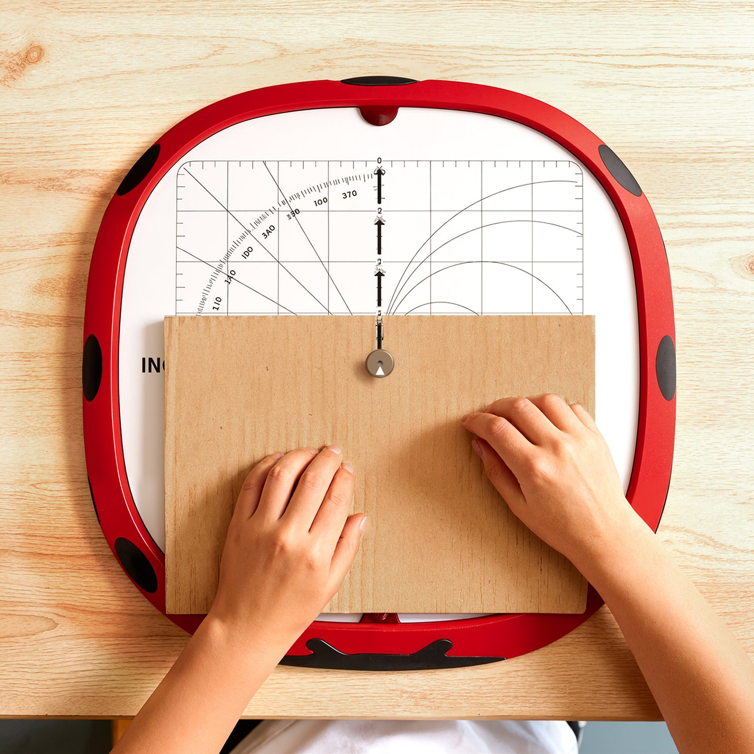Child using the Kidinno cardboard cutter to safely cut cardboard for DIY craft projects and creative STEAM activities.